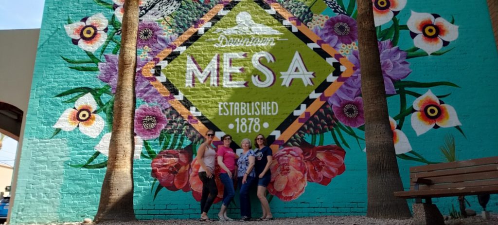 Photo of us in front of the Mesa mural